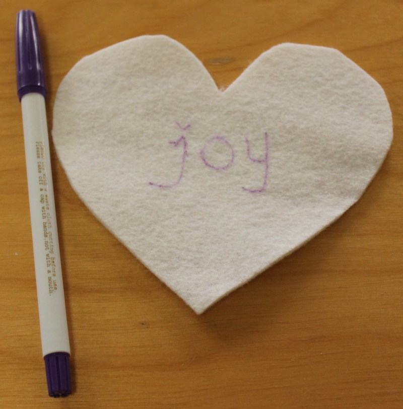 Drawing the word before embroidering.