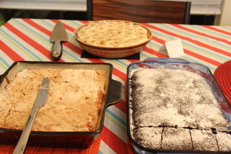Blueberry crumble cake (bottom left), banana cream pie (top), chocolate crazy cake (bottom right)