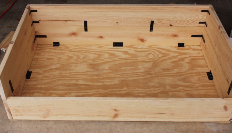 After the sides were assembled, I attached the bottom with L shaped brackets that had 2 or 3 screws in a horizontal line on each side.